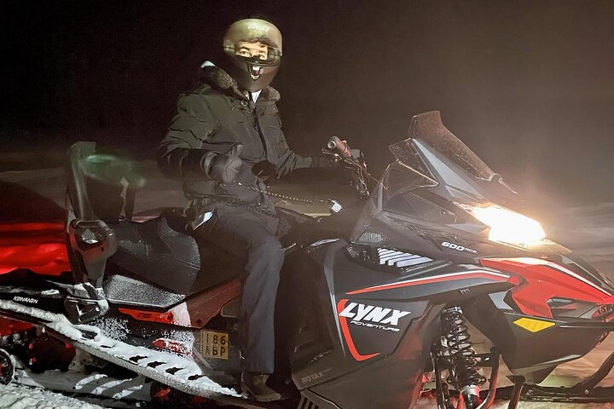 a man is sitting on a motorcycle in the snow