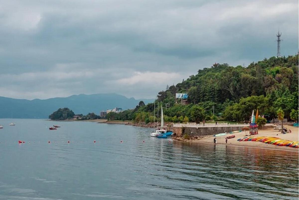 a body of water with a beach and boats on it