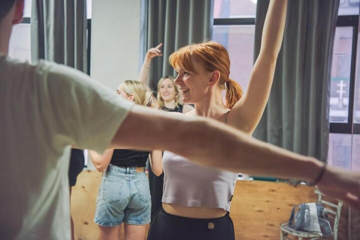 a group of girls standing in front of a mirror