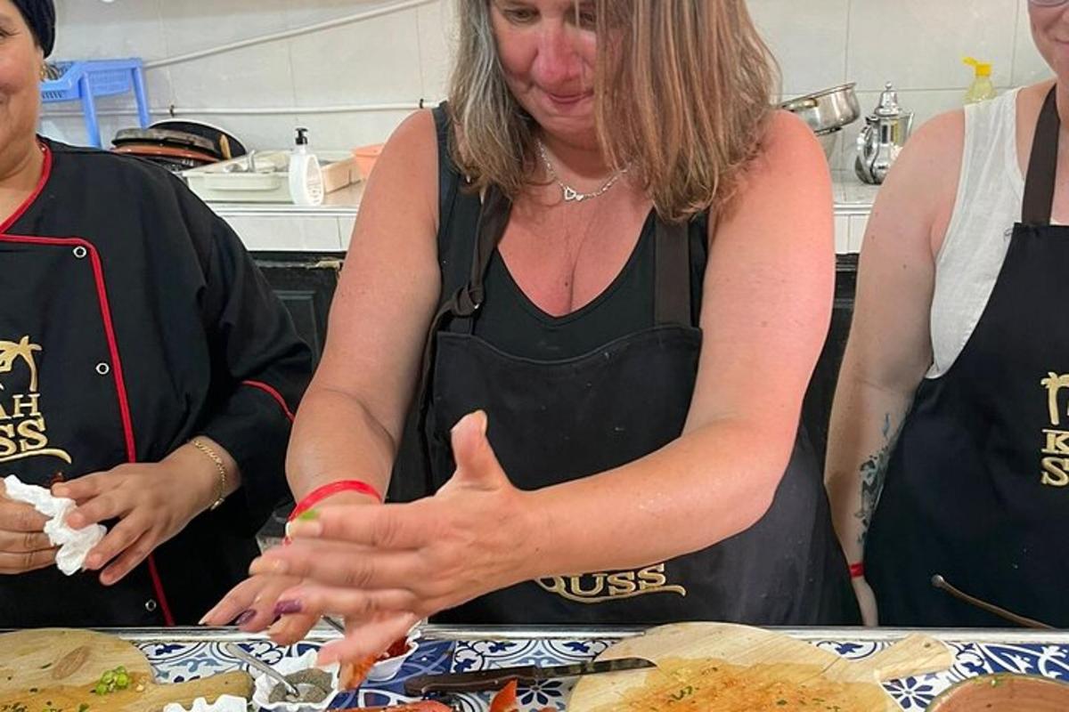 a woman standing in a kitchen preparing food