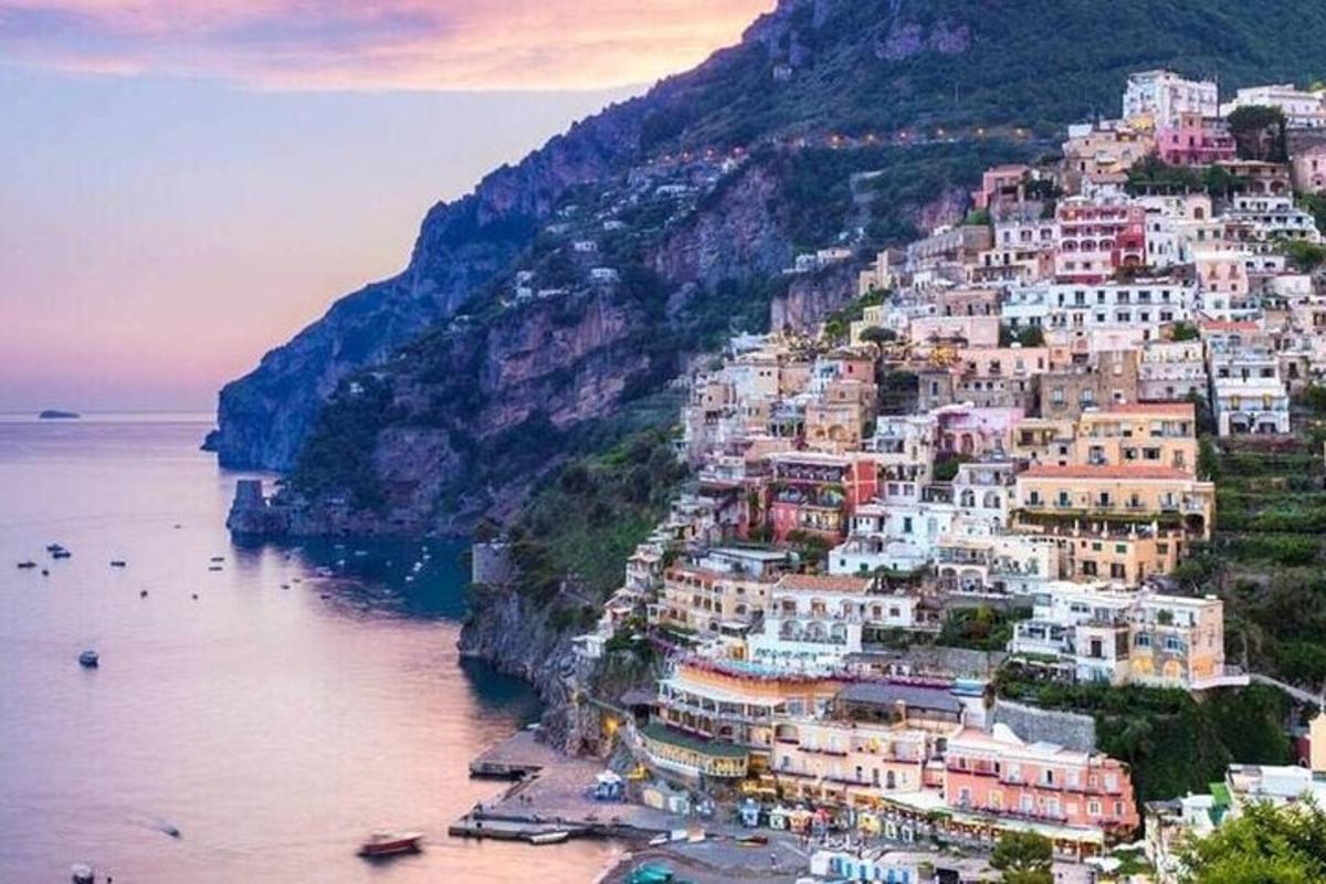 a town on the side of a mountain next to the water
