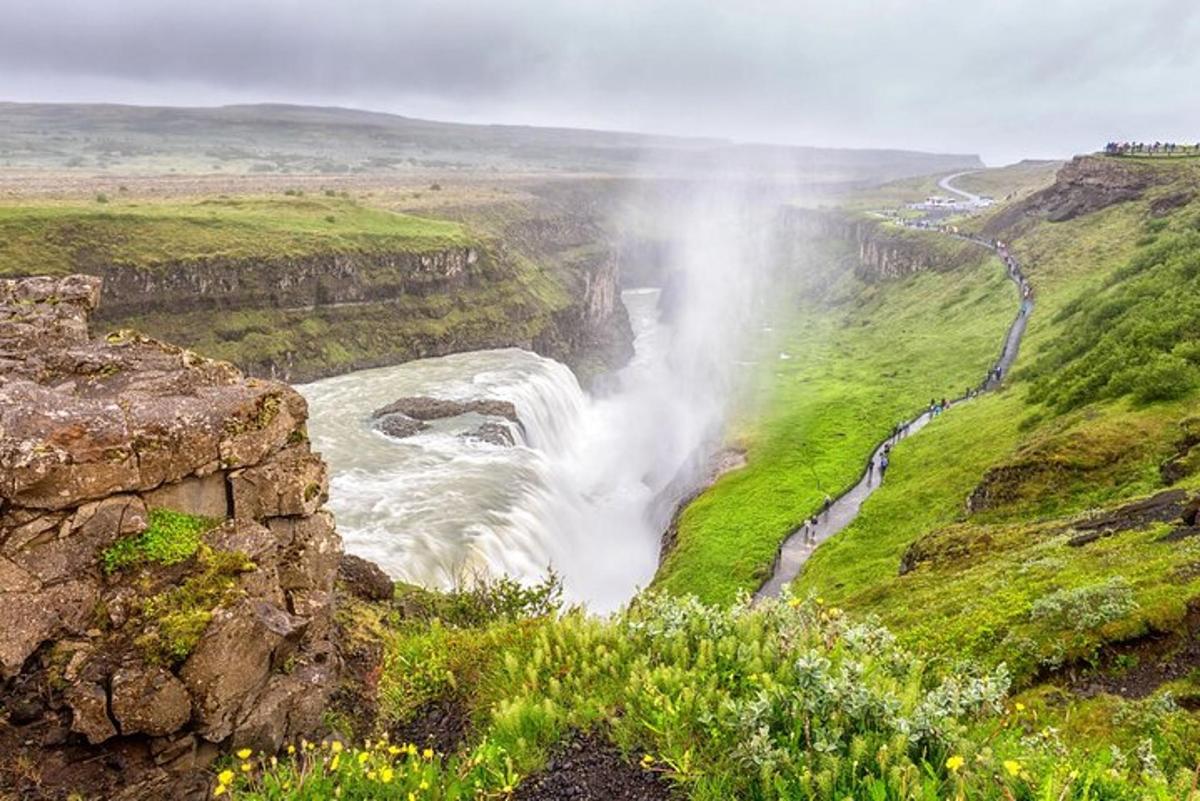 ein Wasserfall in der Mitte einer Schlucht mit einem Fluss