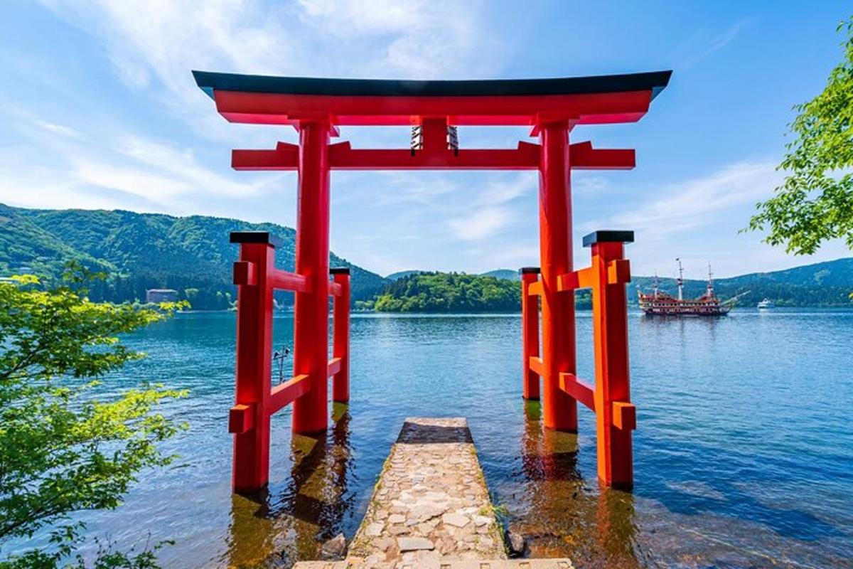 a red torii gate in the middle of a body of water