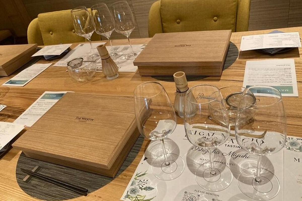a table with wine glasses and a box on it