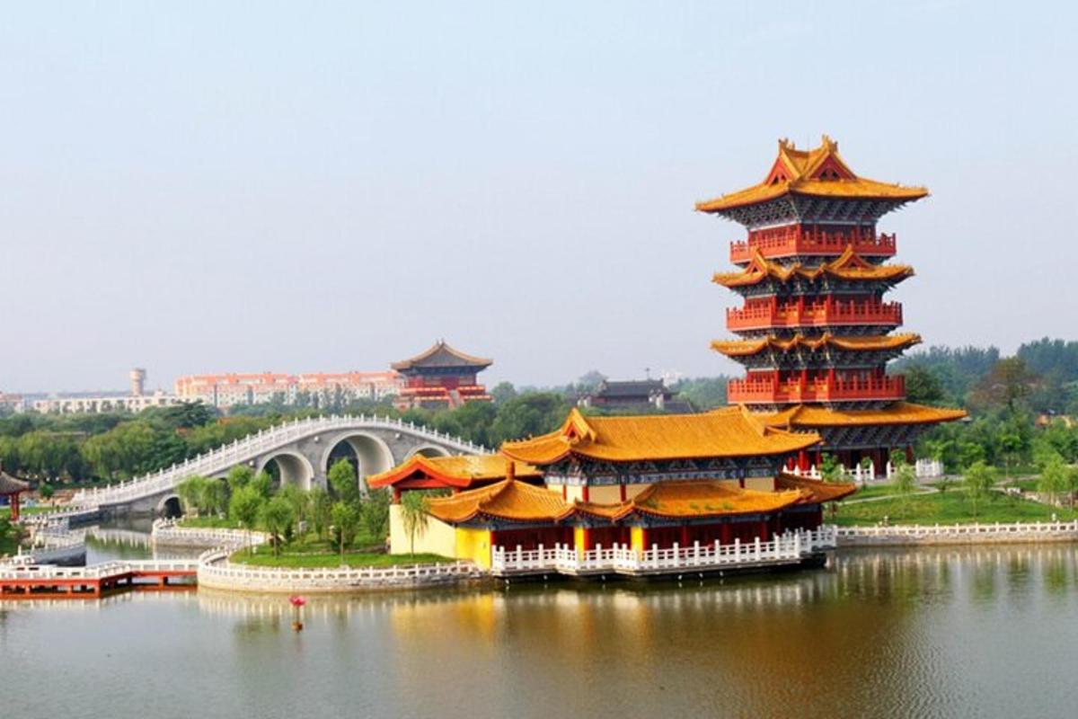 a group of buildings in the water with a bridge