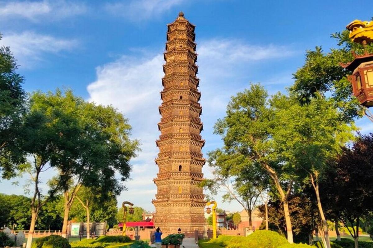 a large tall tower in a park with trees