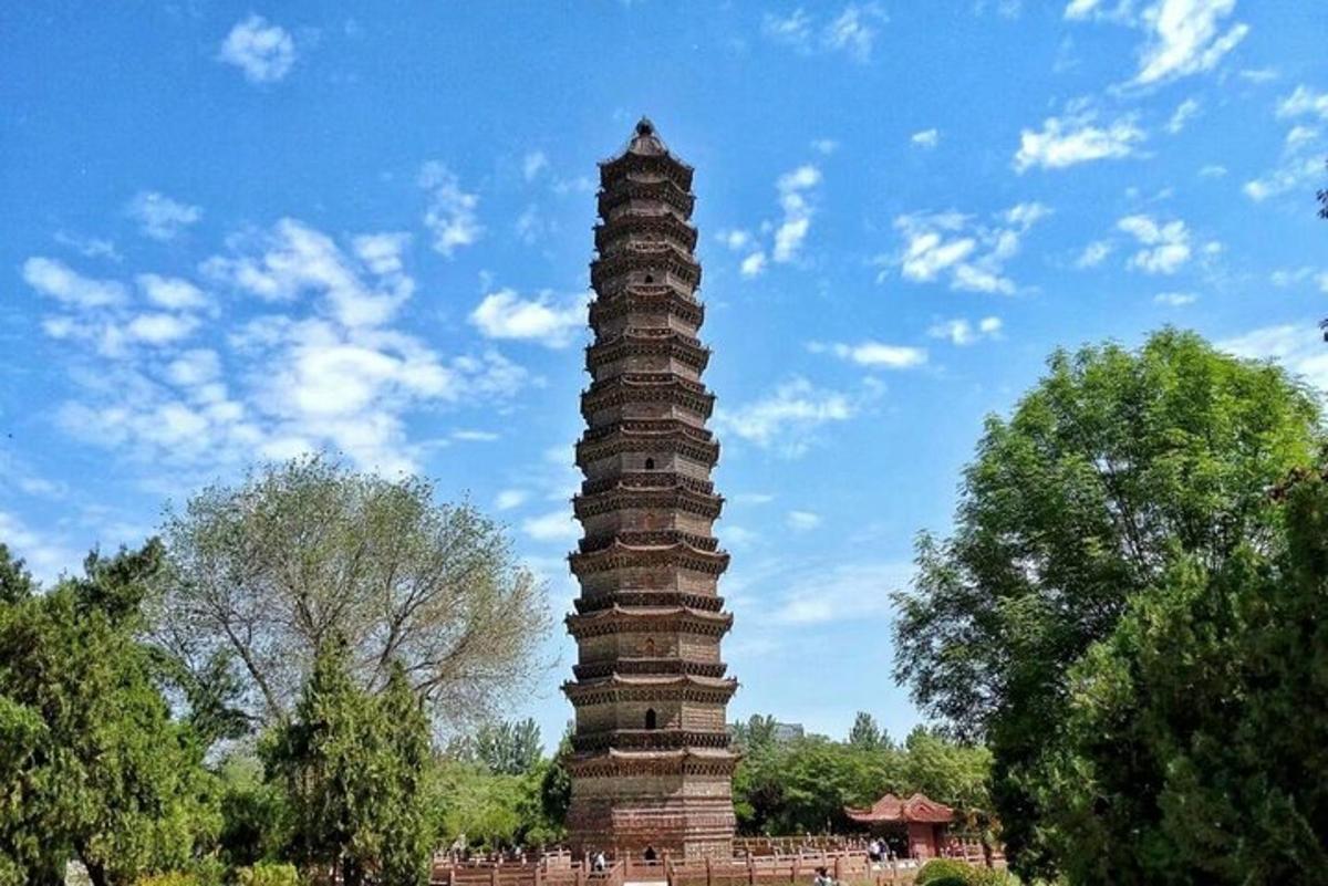 a tall tower in a park with a sky