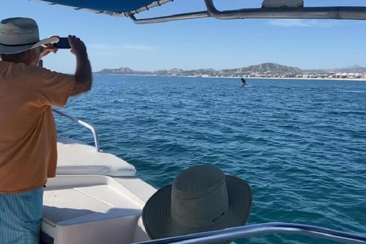 a man taking a picture of the water on a boat