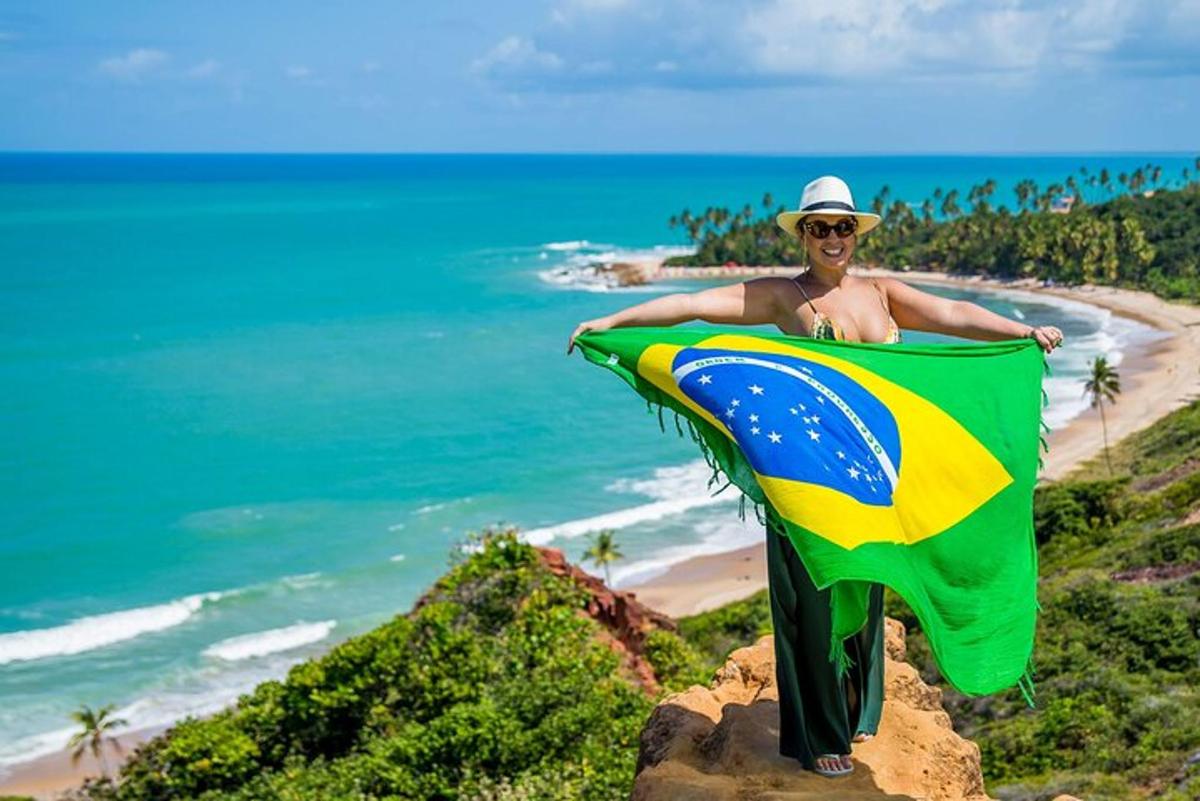 a man holding a flag on top of a beach