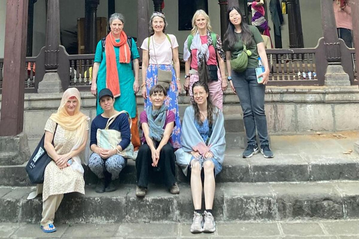 a group of women sitting on steps in front of a building