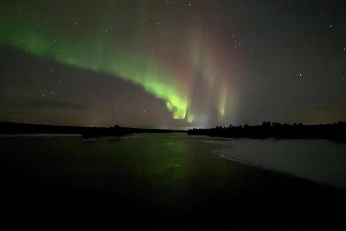 an aurora in the sky over a body of water