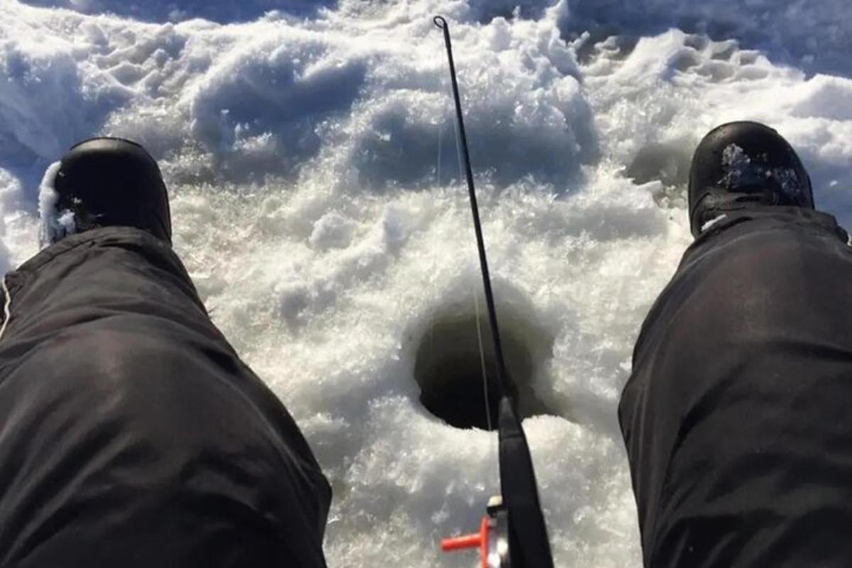 two people holding a fishing pole in front of a cloudy sky