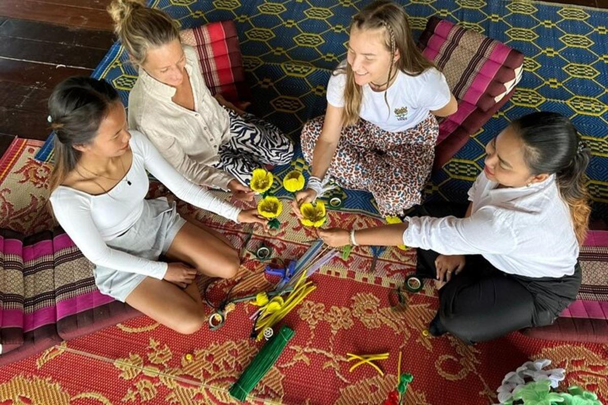 a group of girls sitting on a couch playing with flowers