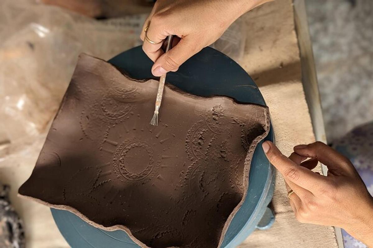 a person cutting a chocolate cake with a knife