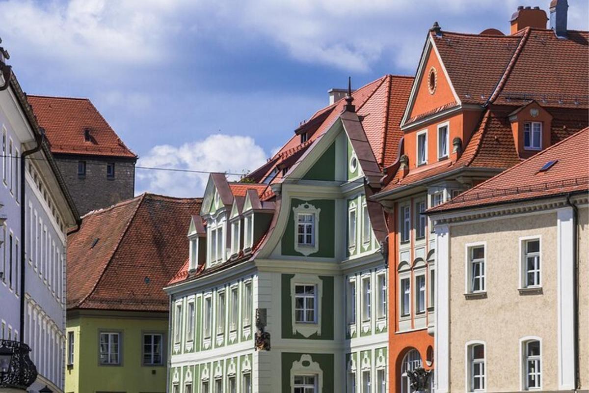 a row of colorful buildings with red roofs