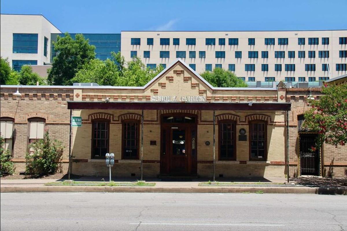 an old brick building with a door in a city