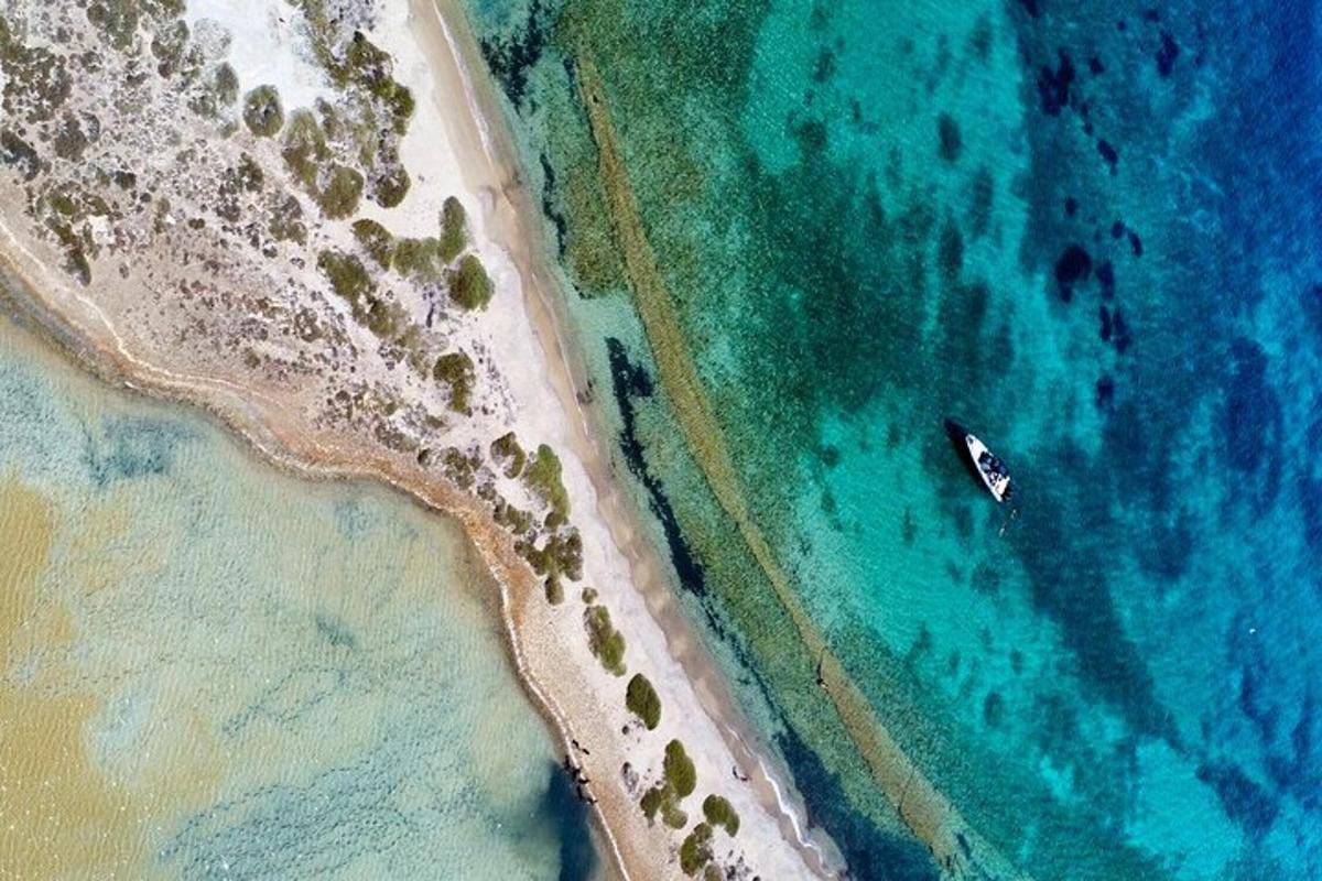 an aerial view of a boat in the ocean