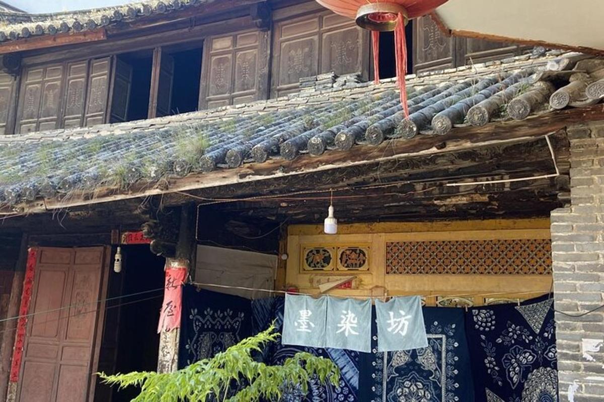 an old building with a roof with chinese signs on it