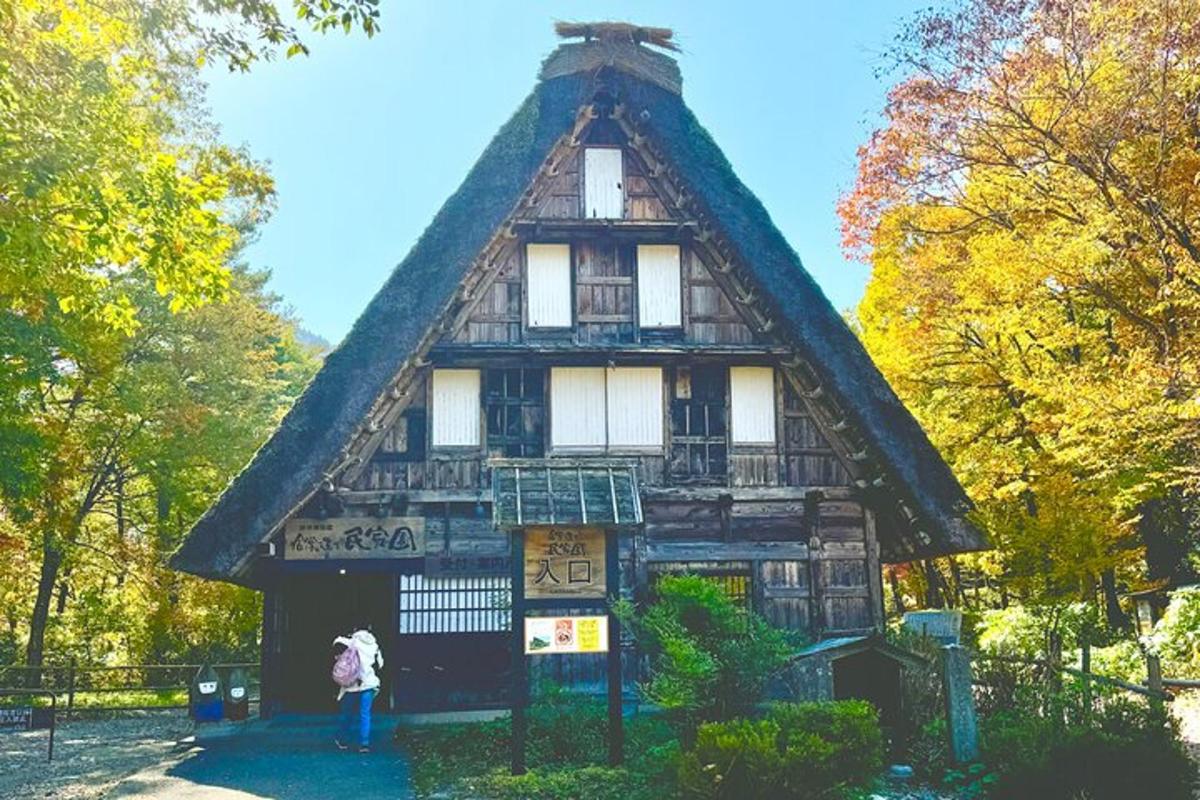 a woman standing in front of a large house