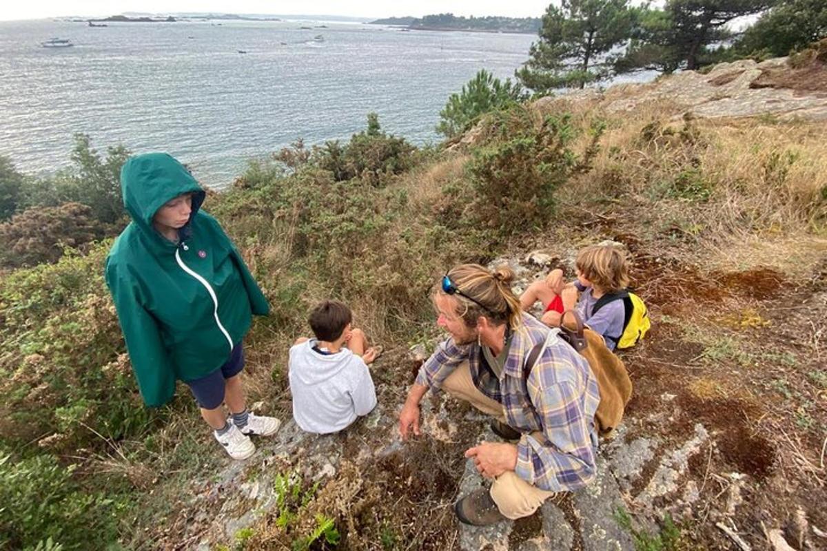 a group of people on a hill near the water