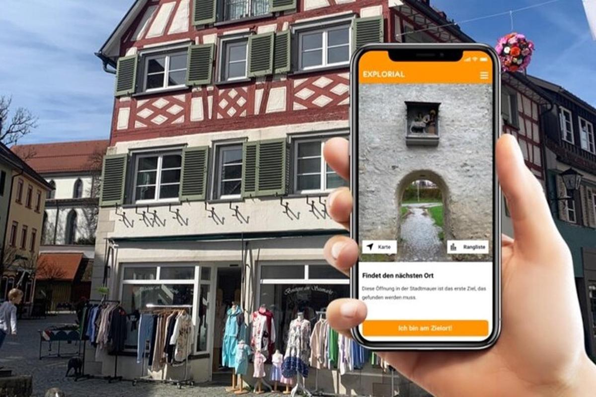 a person holding up a cell phone in front of a building