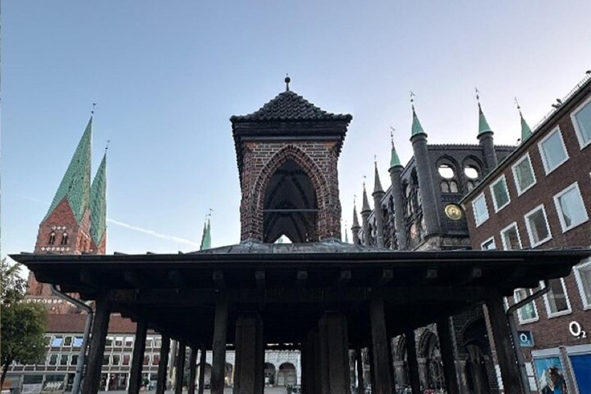 a large building with a clock tower in a city