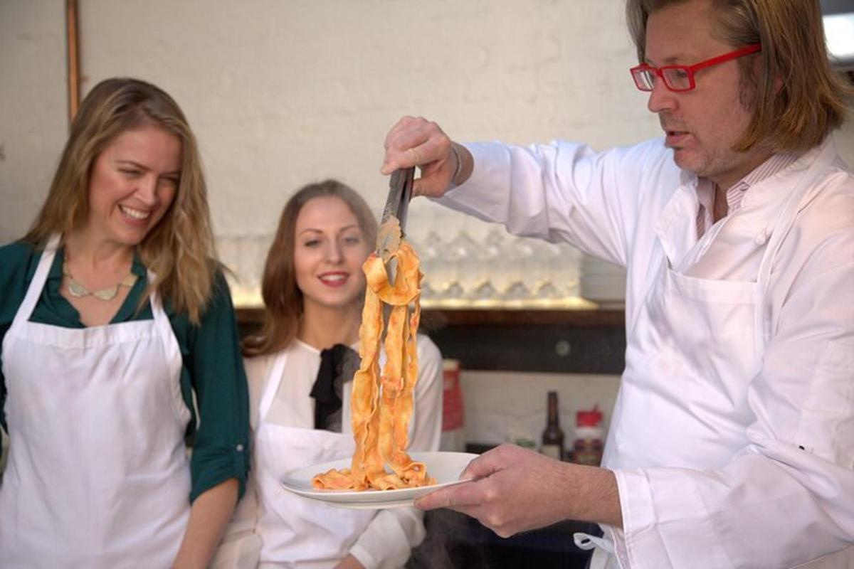 a man is holding a plate of food with a spoon