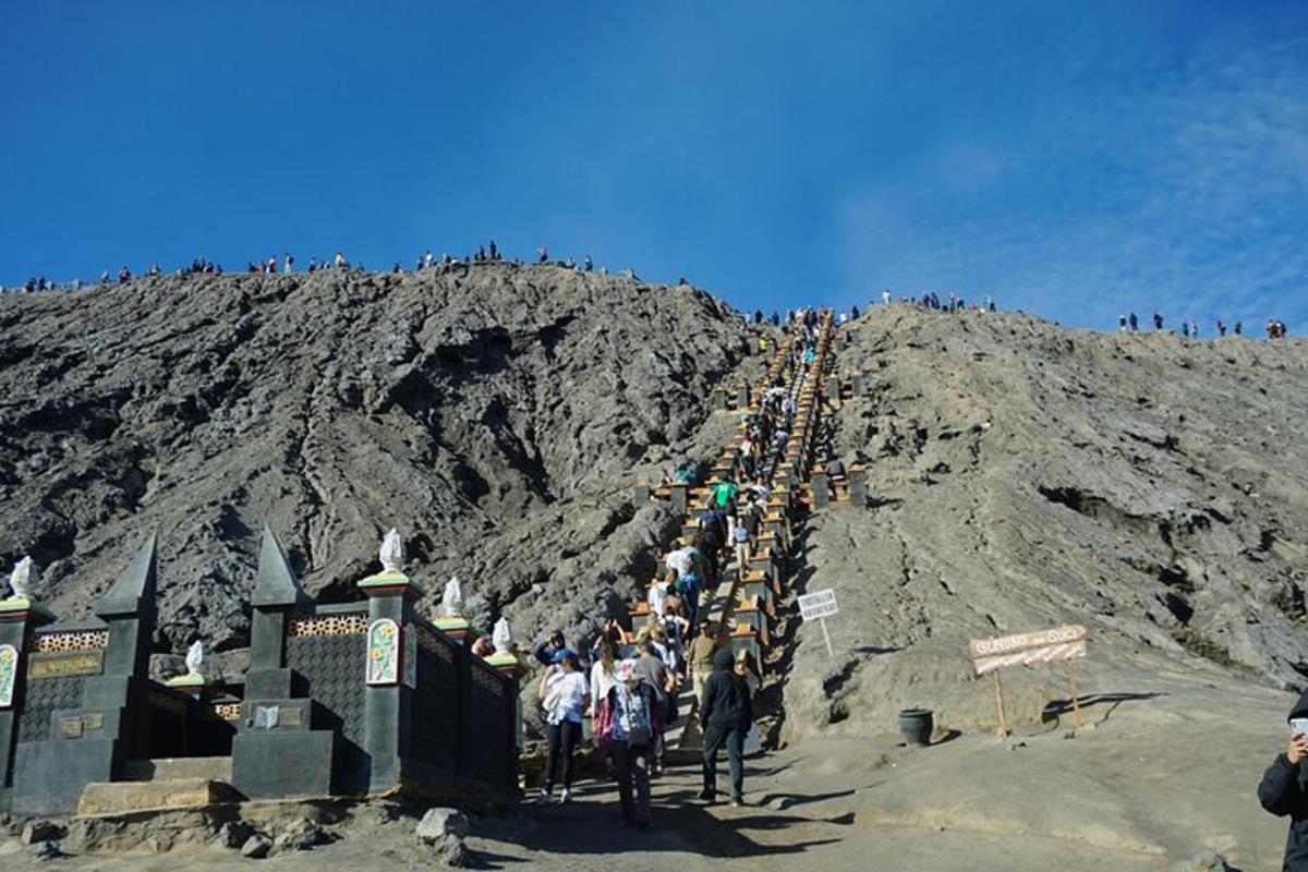 a group of people walking up a mountain