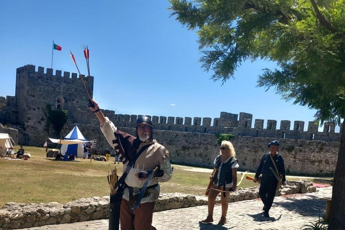 um homem fantasiado em pé em frente a um castelo