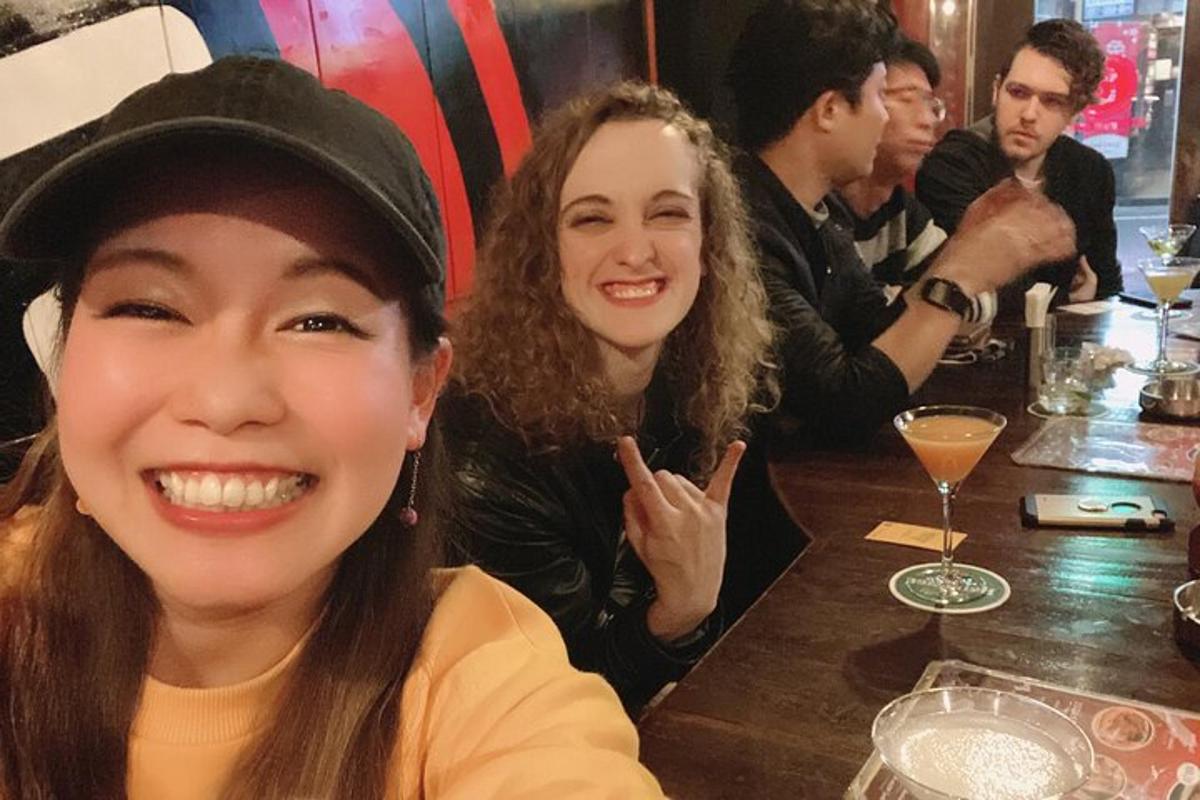 two women sitting at a table in a bar