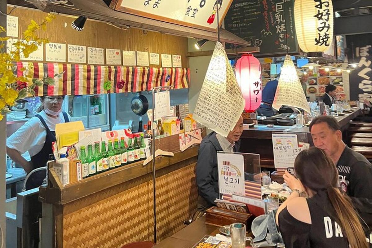 a group of people sitting at a counter in a restaurant