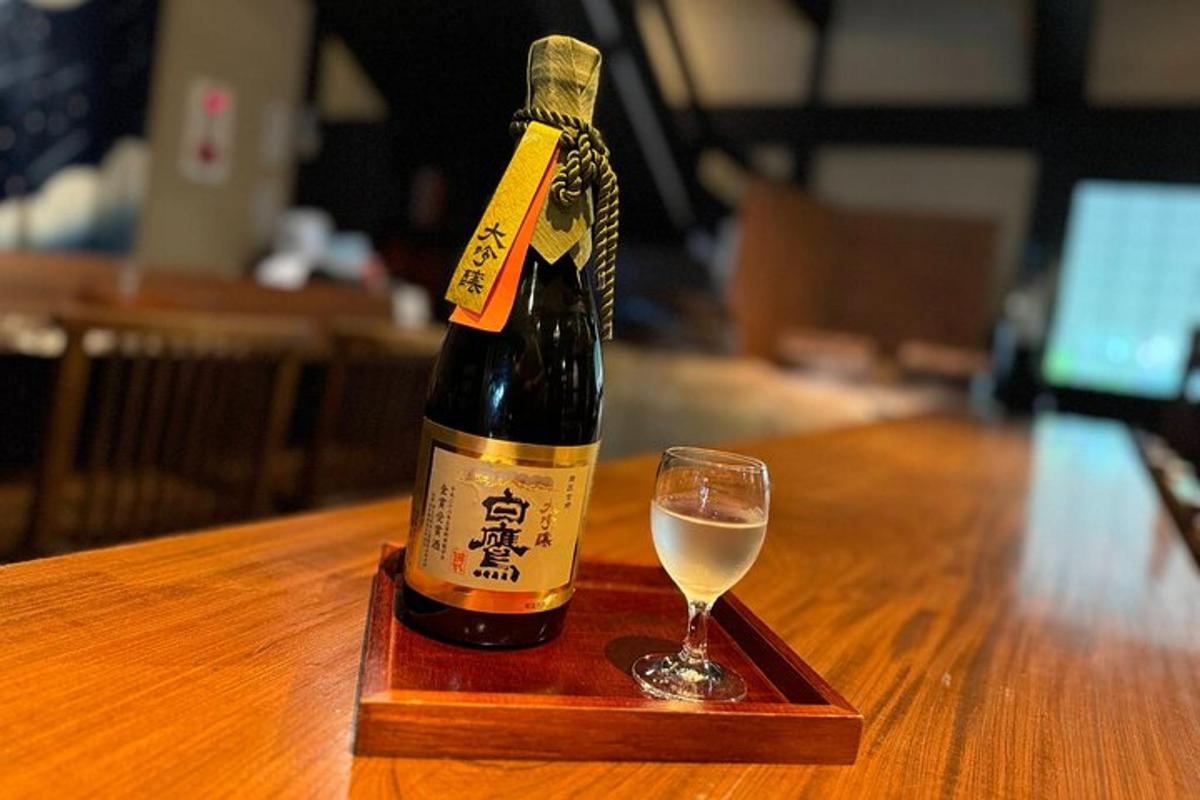 a bottle of wine sitting on a table with a glass