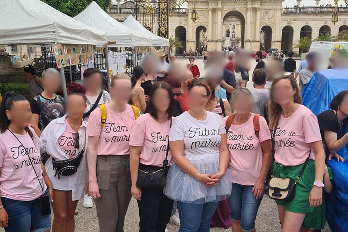 a group of women in pink shirts standing in a crowd