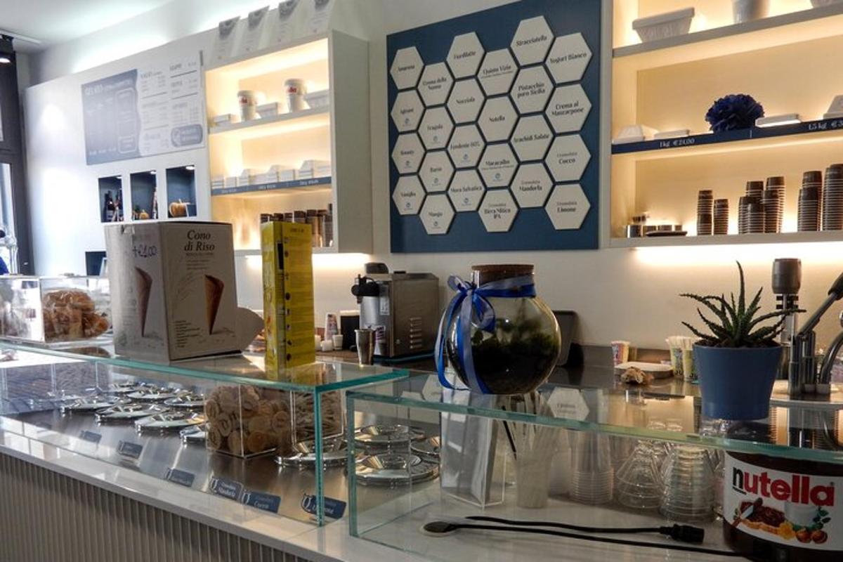 a glass counter in a store with vases on it