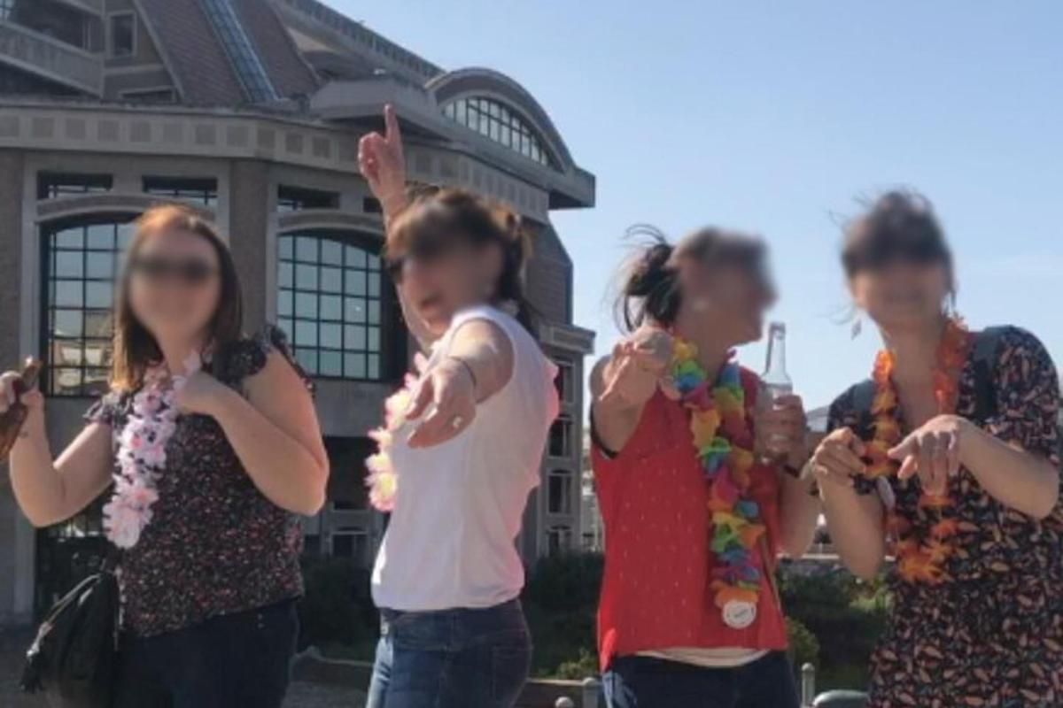 a group of young girls standing in front of a building