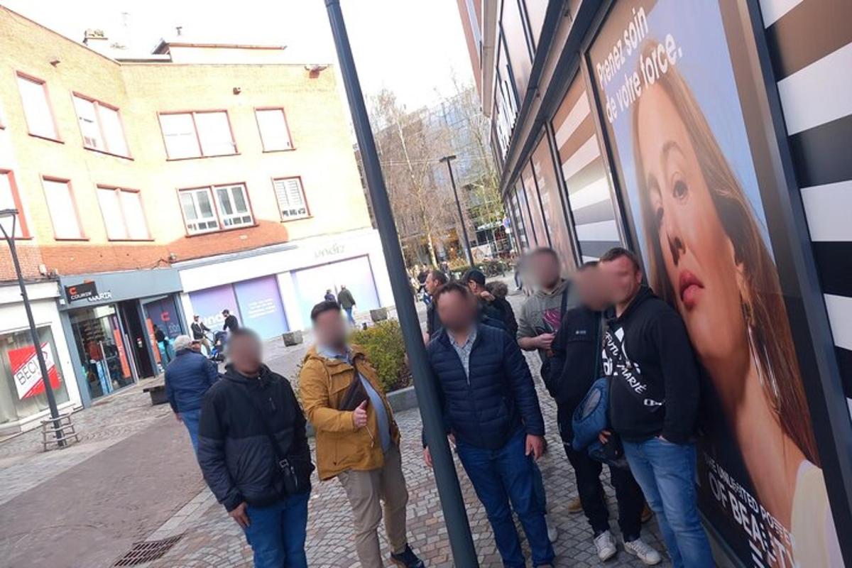a group of people standing outside of a store