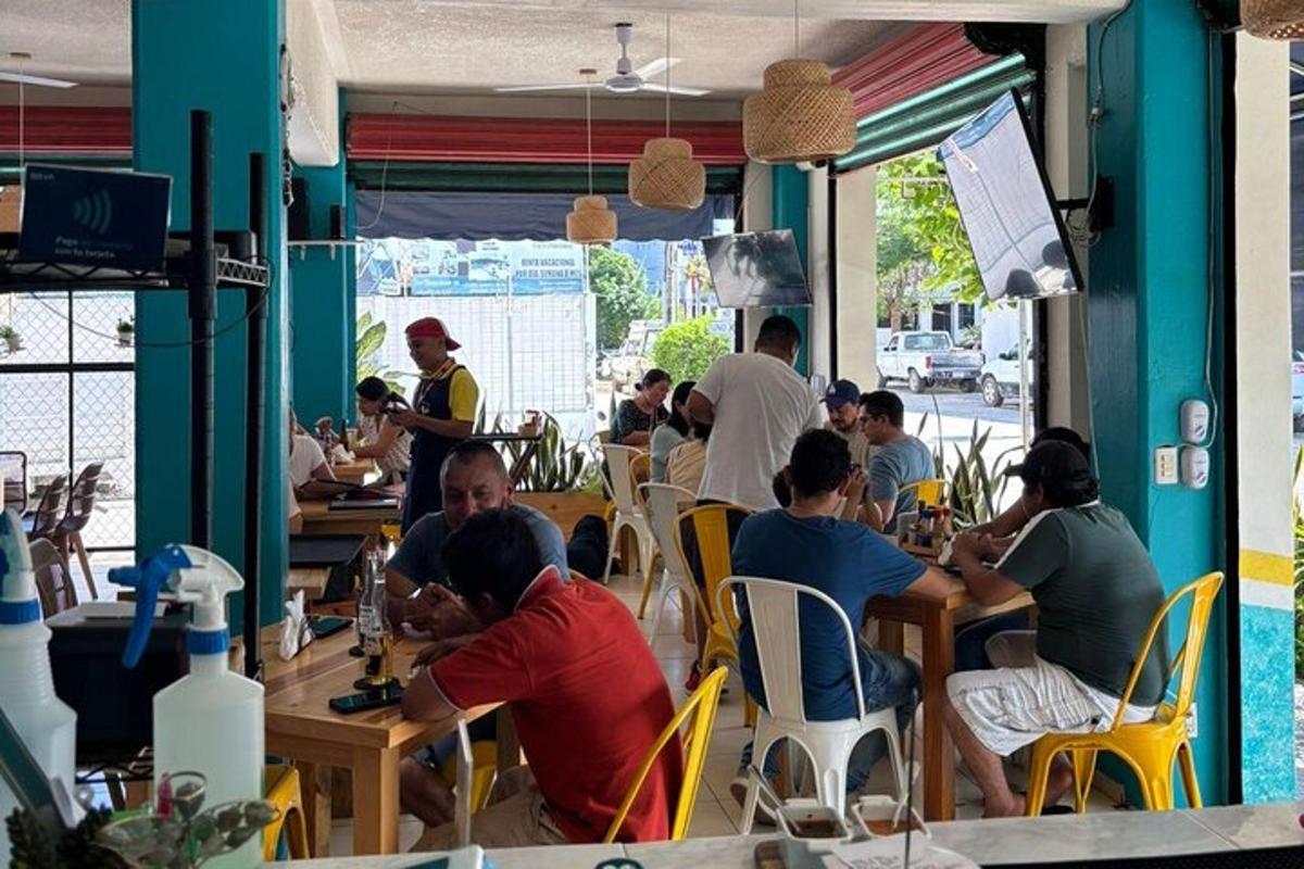 a group of people sitting at tables in a restaurant