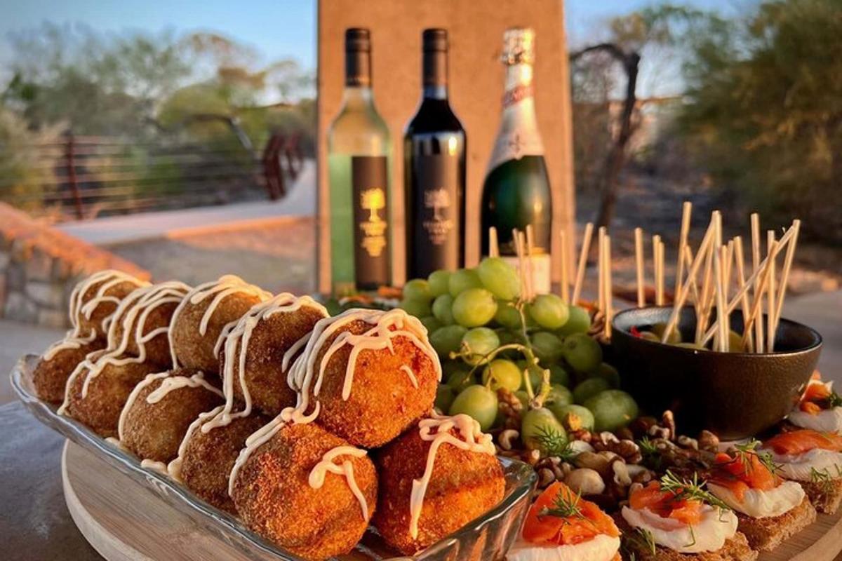 a table with bottles of wine and a plate of food