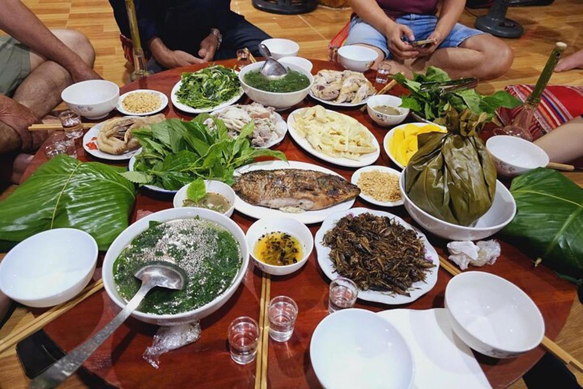 a group of people sitting around a table full of food