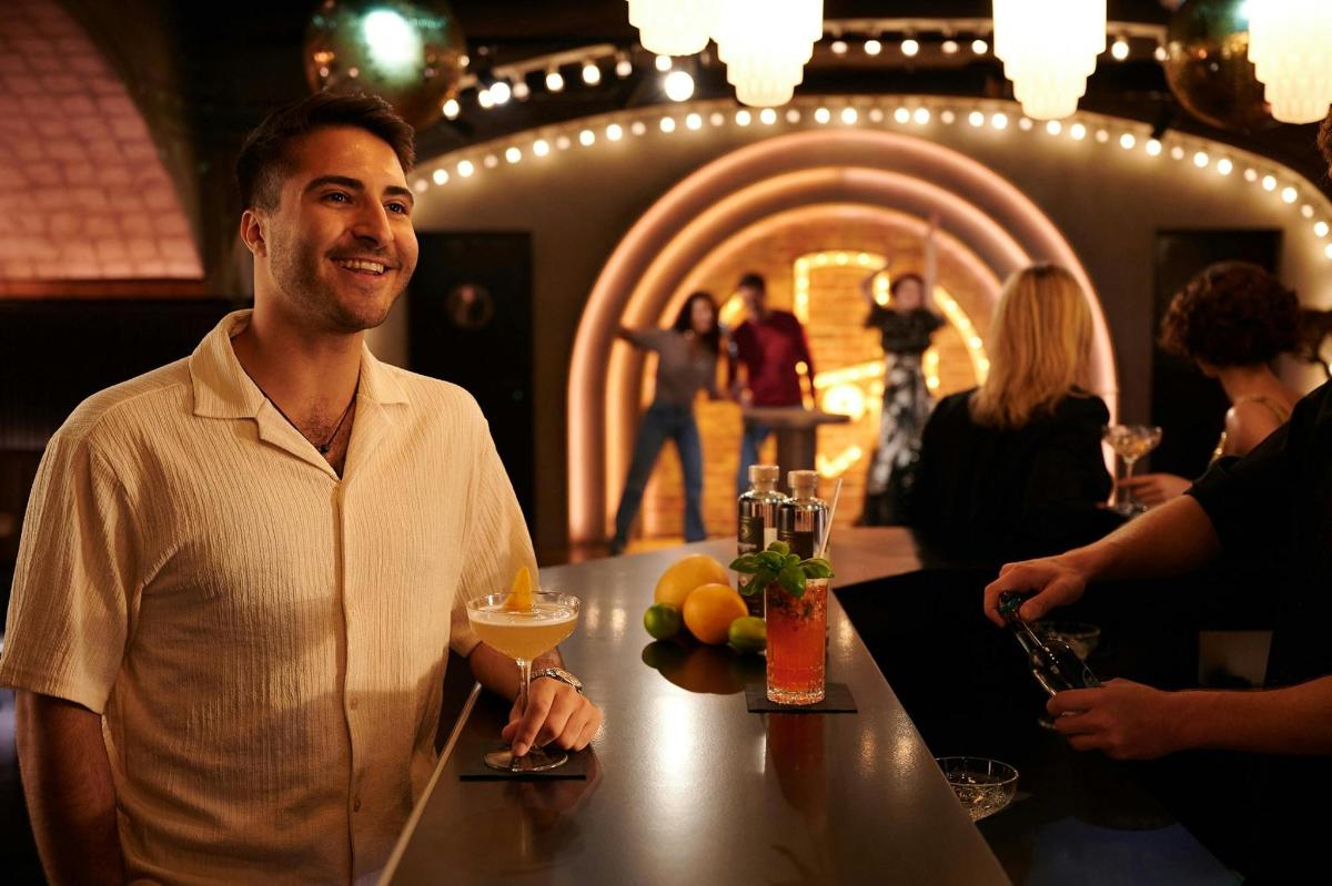 a man sitting at a table in a bar
