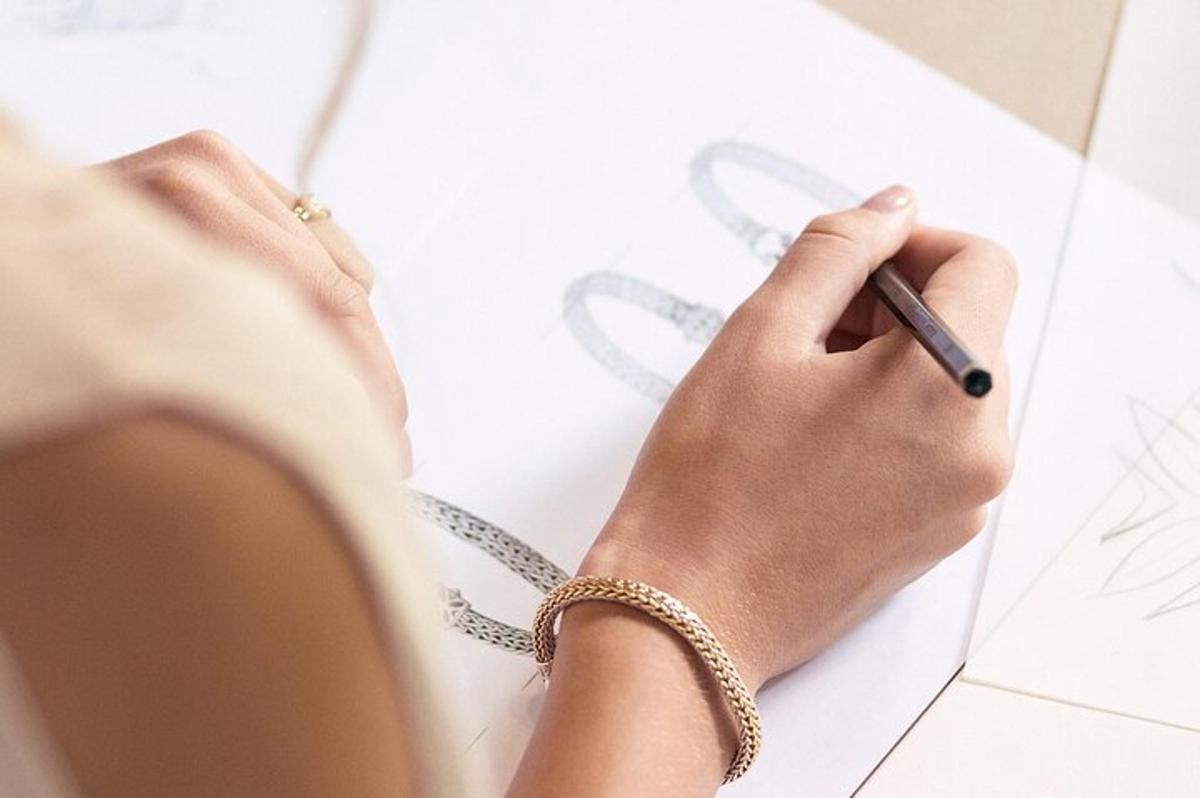 a woman writing on a piece of paper with a pen