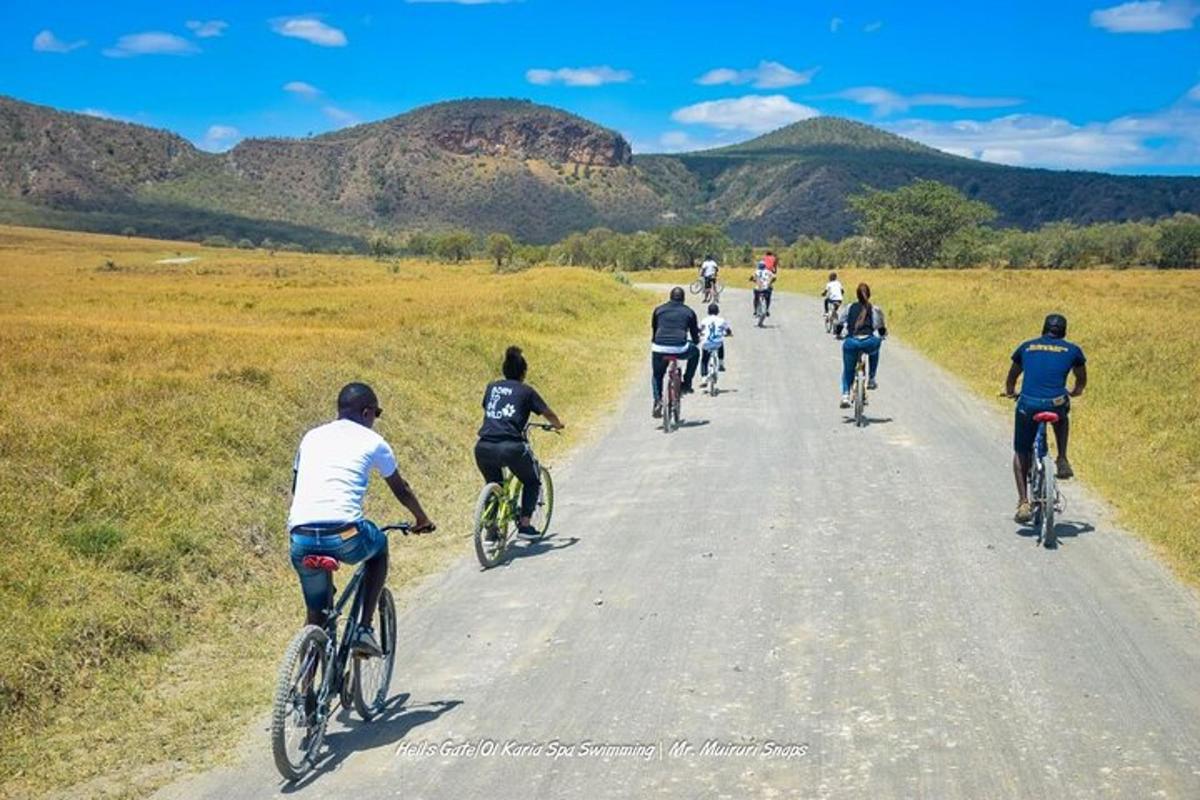 a group of people riding bikes down a road