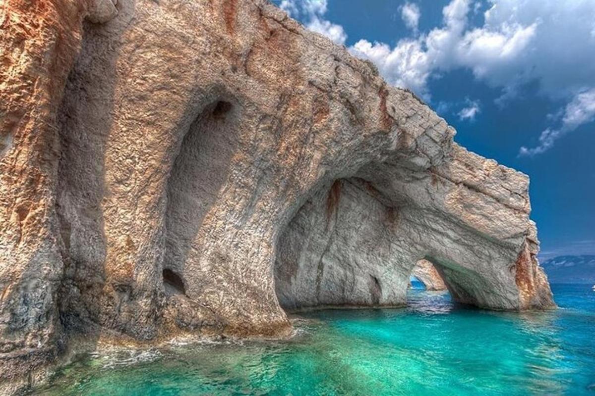 a rock formation in the ocean with blue water