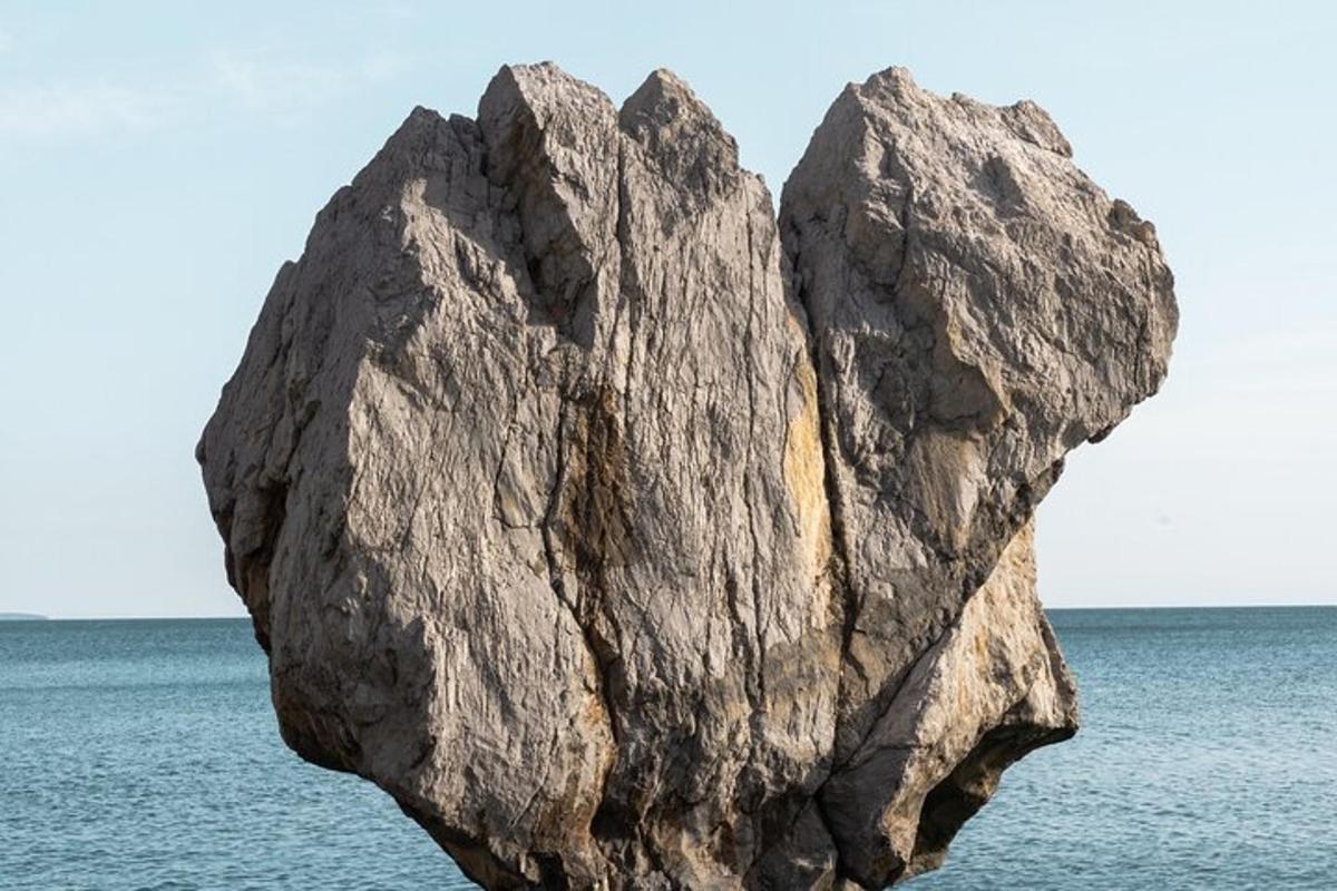 a large rock in the middle of the ocean