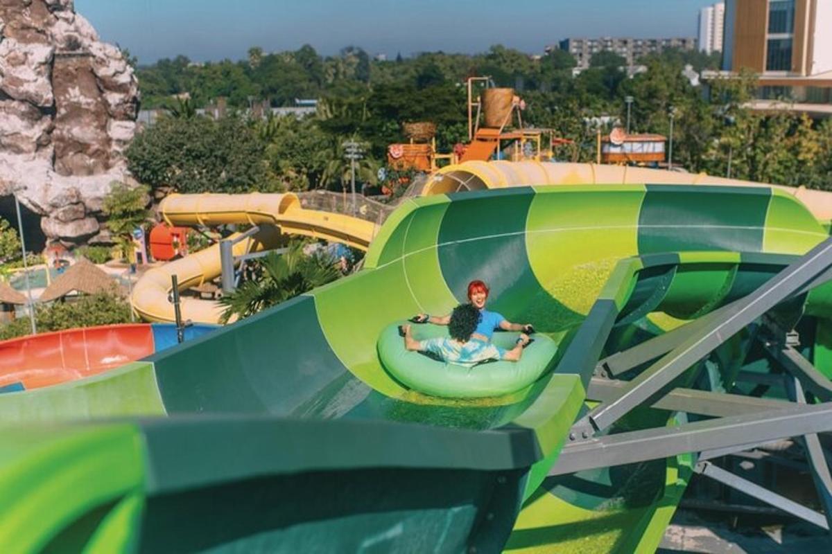 a man riding a ride at a roller coaster