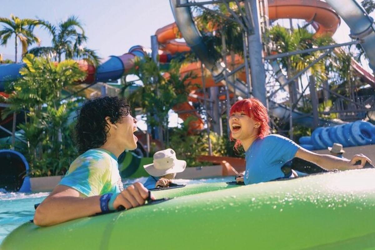 a man and a woman riding on a ride at a water park