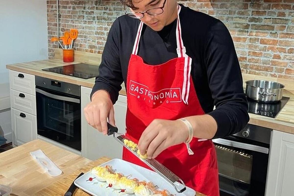 a woman in a kitchen cutting a cake with a knife