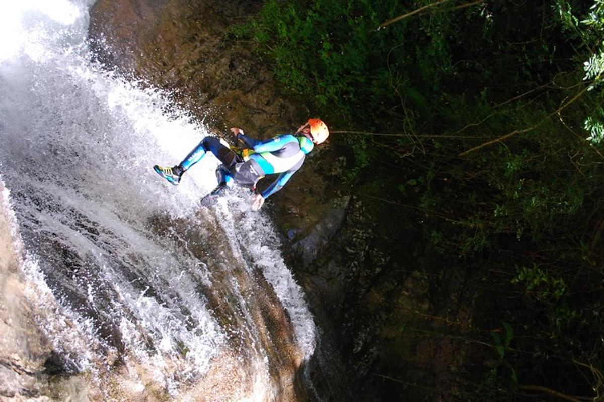 a man riding a wave on top of a waterfall