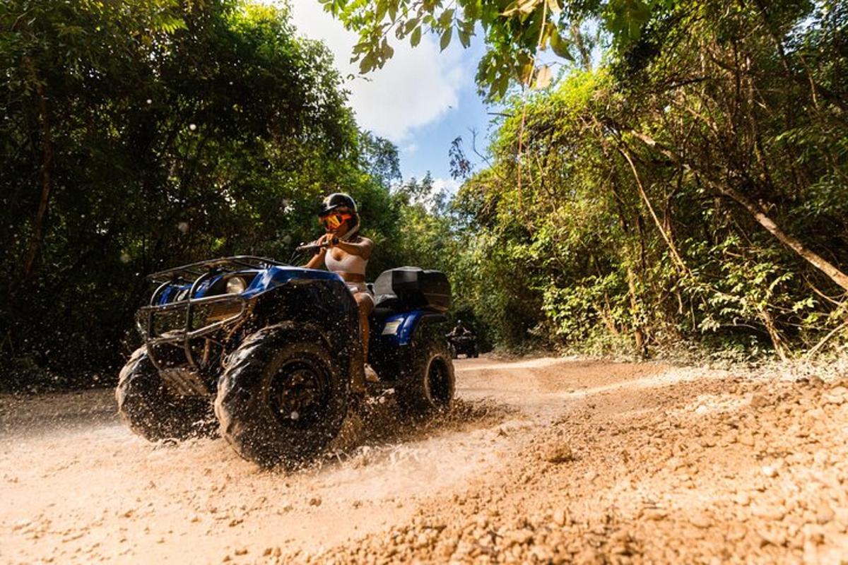a person riding a atv on a dirt road