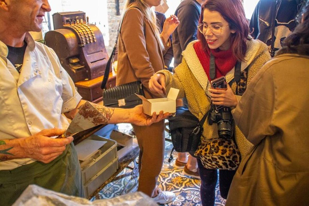 a woman is handing a box to a man in a store